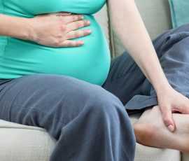 0 pregnant woman massaging her tired feet couch 2